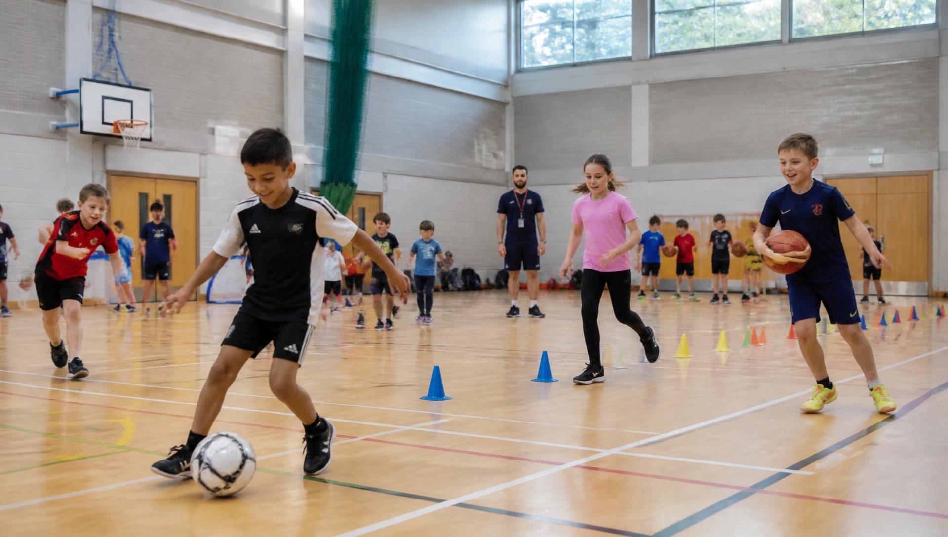 Children playing football, basketball and doing agility drills at an NG Sports multi-sport holiday camp